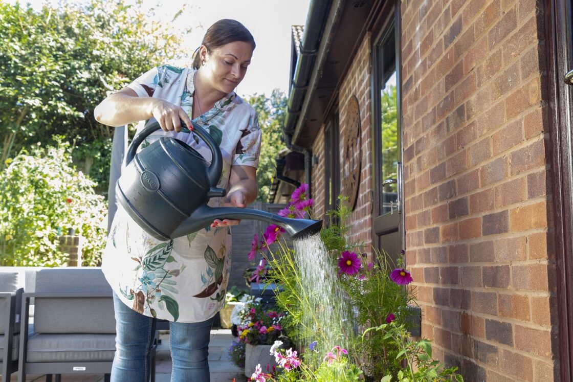 watering plants with a watering can